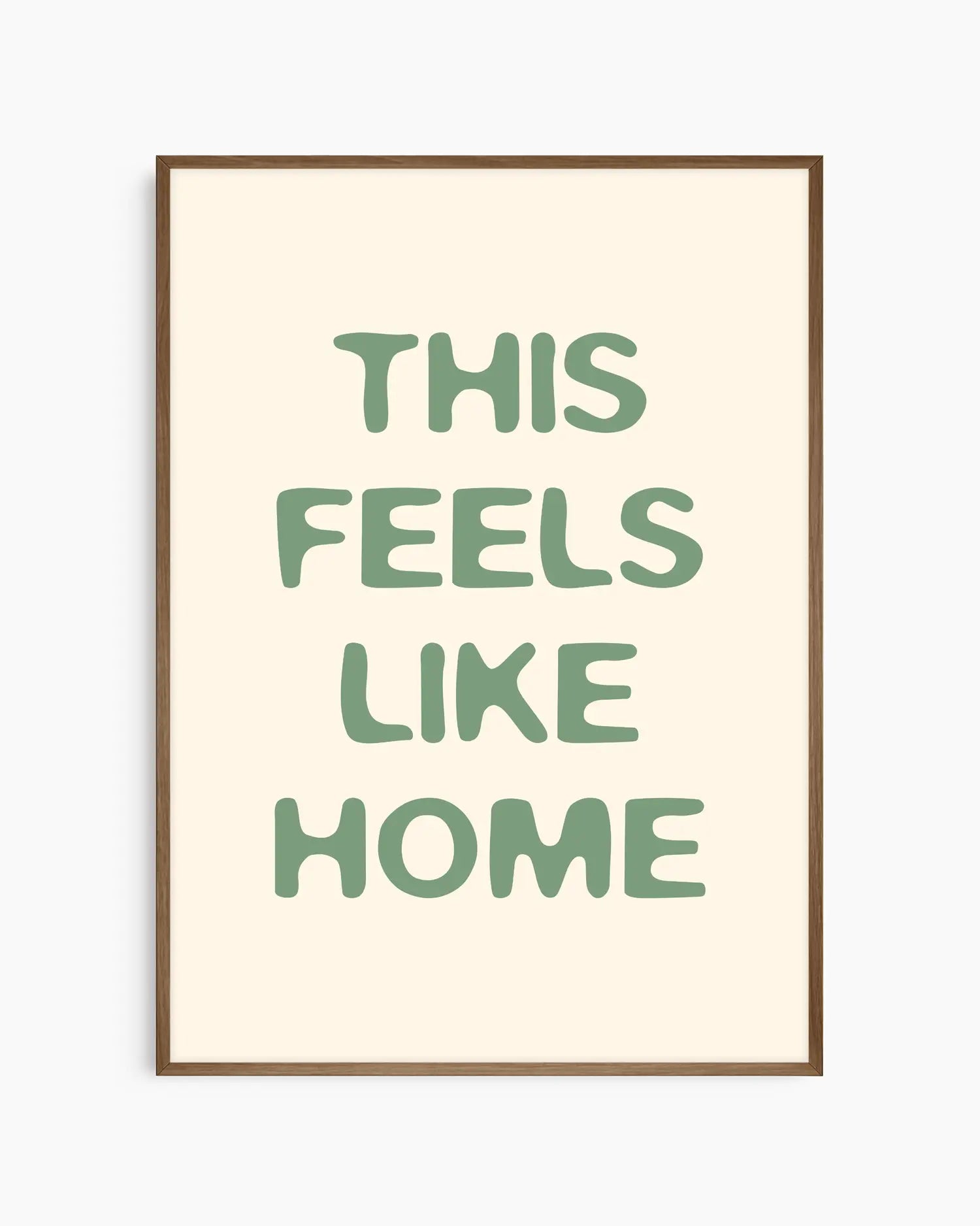 Nursery poster with the text 'This feels like home' written in green, inserted in a dark oak frame