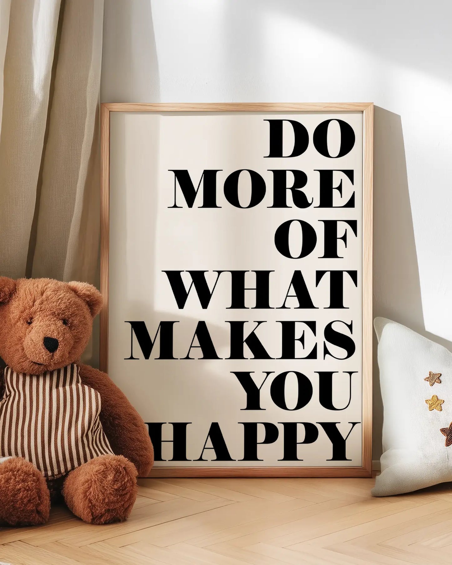 Motivational poster with teddy bear and pillow on a wooden floor