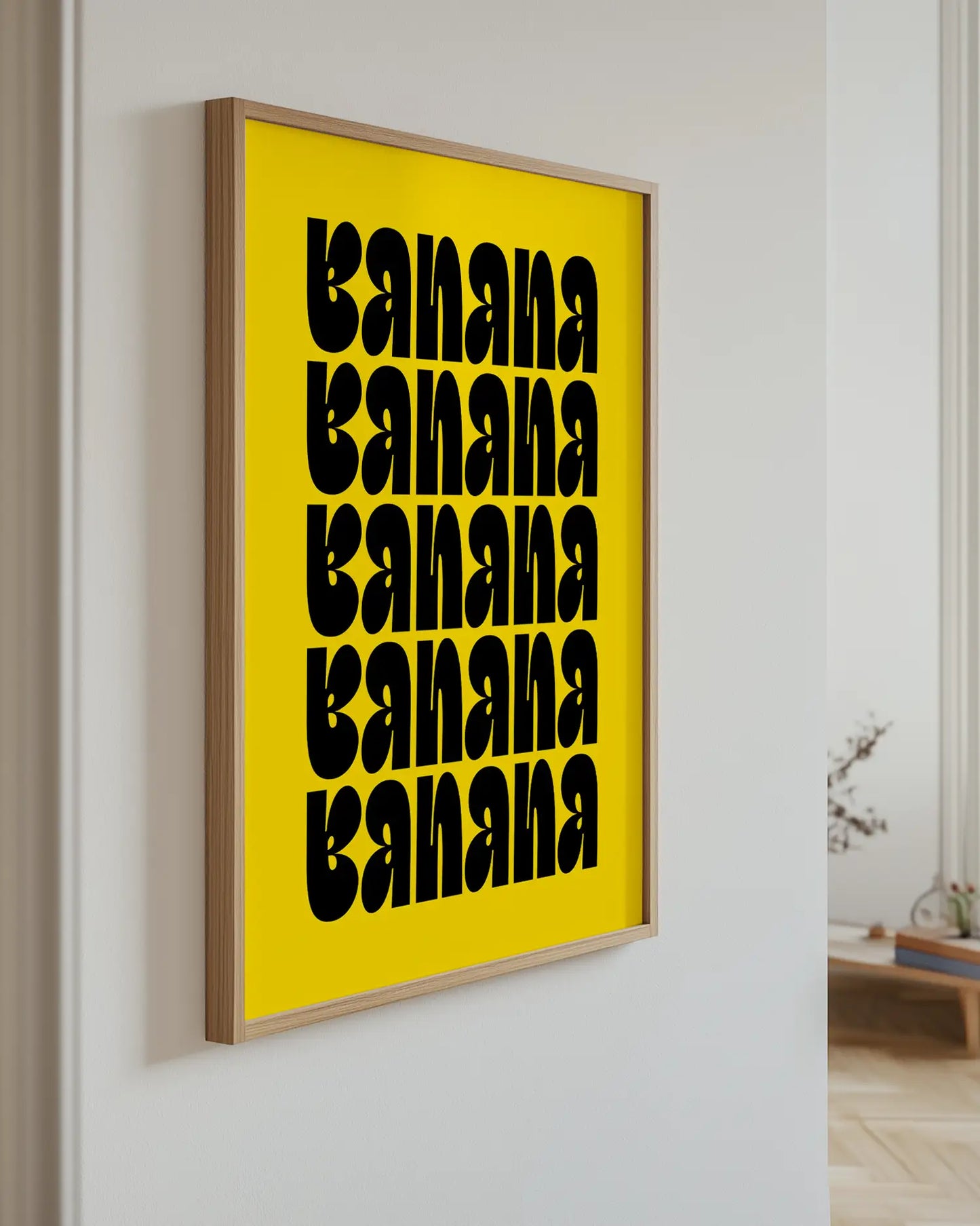 Yellow poster with the text "Banana" hanging on the wall