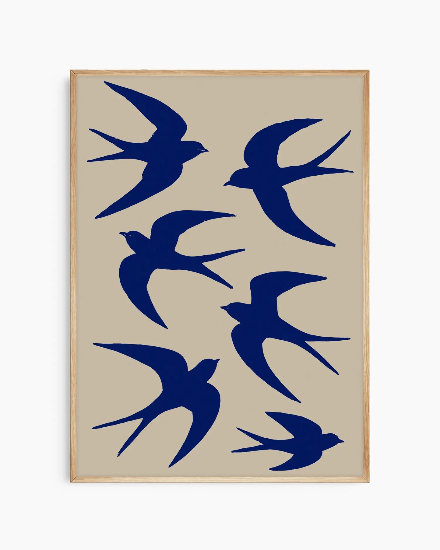 Framed artwork with blue bird silhouettes on a beige background