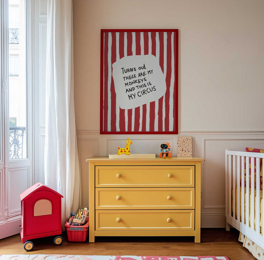 Nursery poster with the text 'Turns out these are my monkeys and this is my circus' on a red and white striped background hanging on a wall above a yellow chest of drawer.