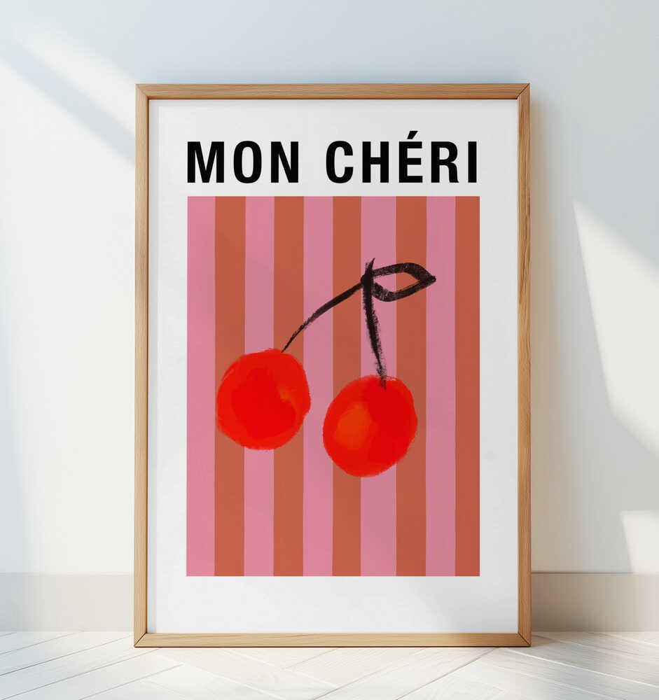 Framed nursery poster of two red cherries on a striped pink and orange background and the text 'MON CHÉRI' on top