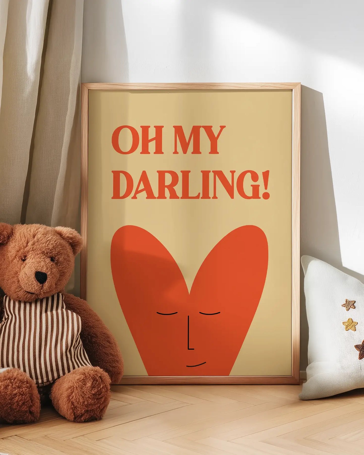 Framed artwork with 'OH MY DARLING!' text and a heart design, next to a teddy bear and decorative pillow.