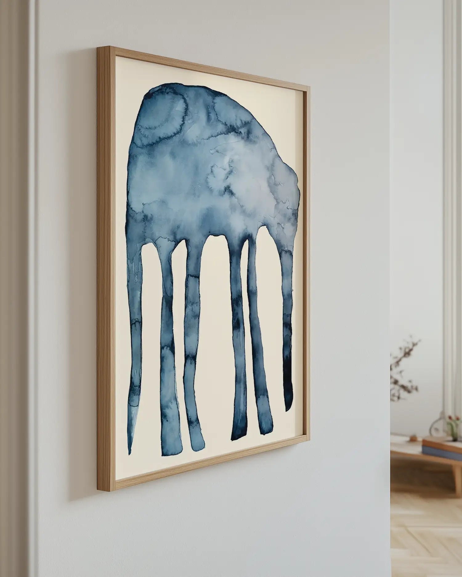 Framed artwork of a blue elephant on a white wall.
