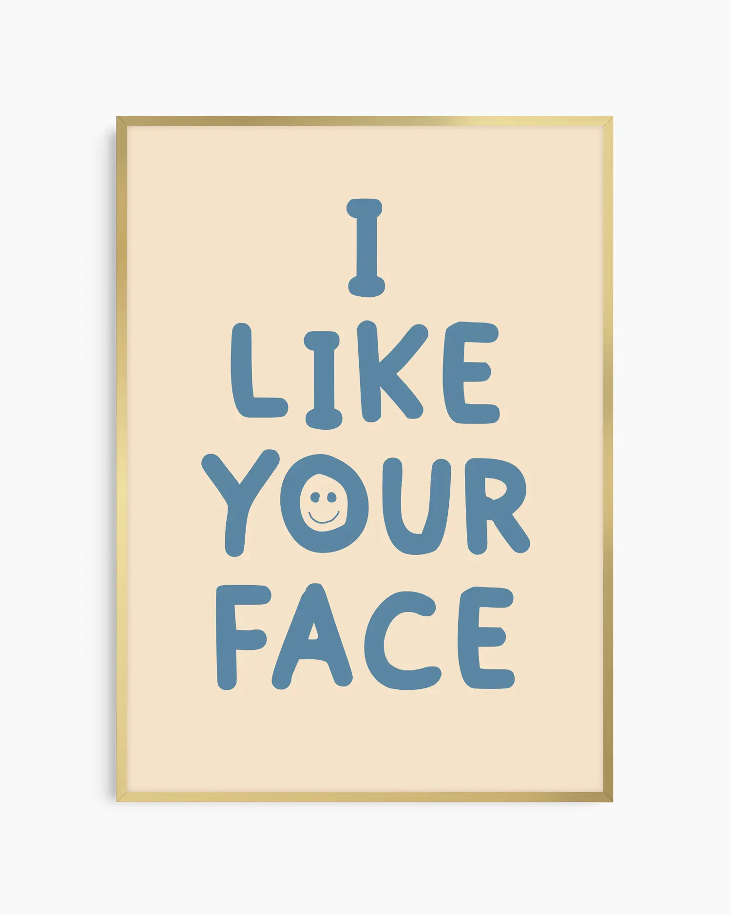 Beige nursery poster with the text 'I like your face' written in blue, framed in a gold frame.