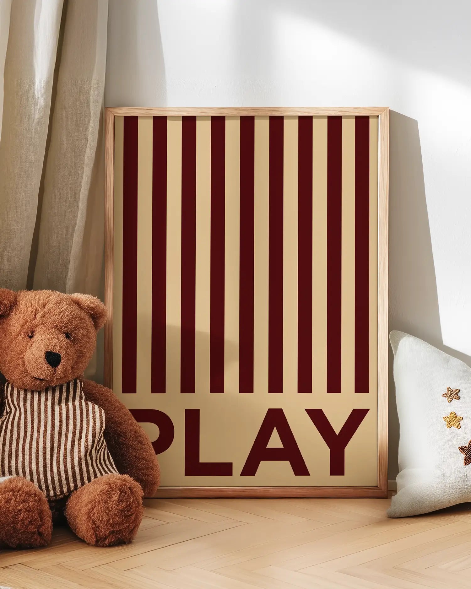 Poster with the text 'PLAY' written on it, next to a teddy bear.
