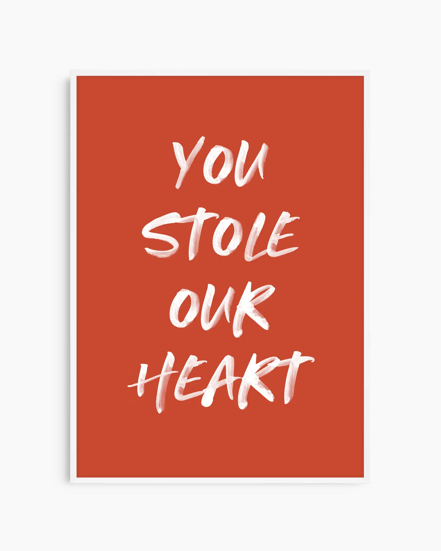 Nursery poster with white text 'You stole our heart' on a red background. White frame.