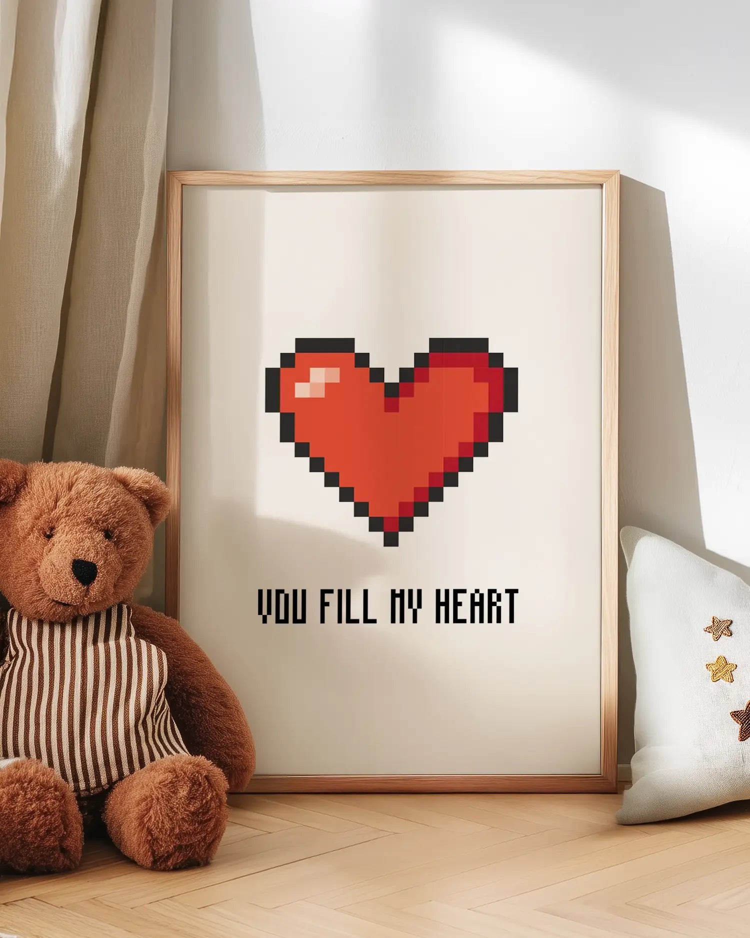 Pixel heart artwork with teddy bear and pillow on wooden floor