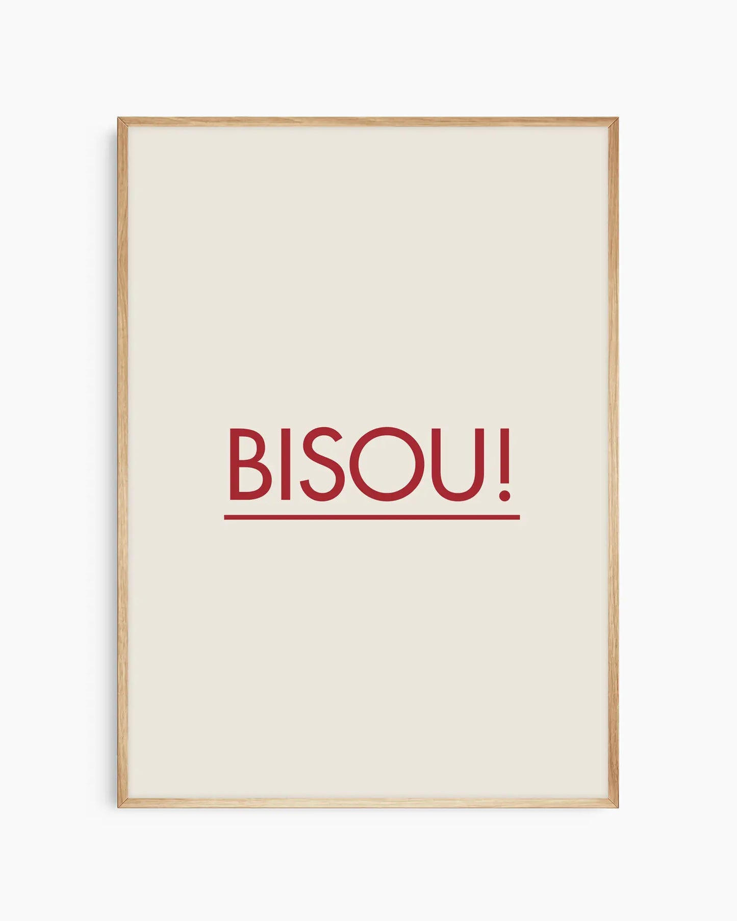 Framed poster with red 'BISOU!' text on a white background, framed in an oak wooden frame.