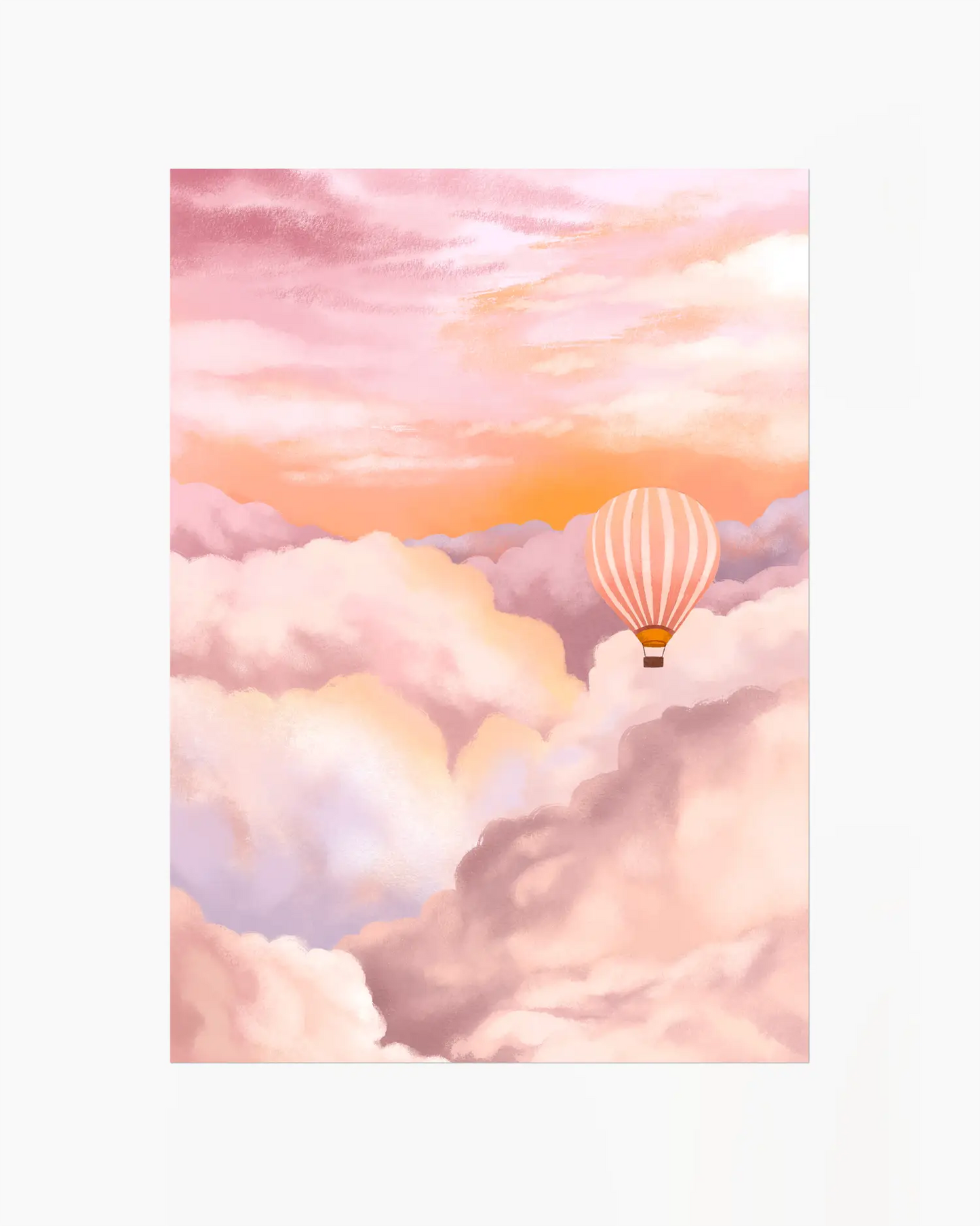 Hot air balloon in a pink and orange sky with clouds