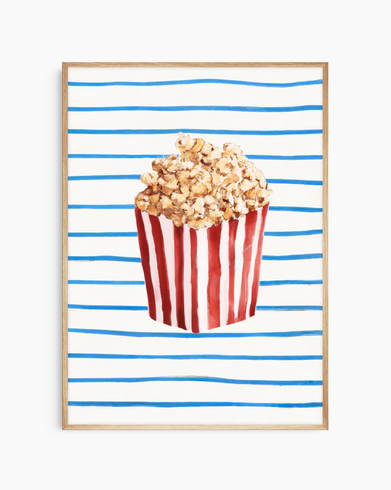 Popcorn in a red and white striped bucket on a blue and white striped background
