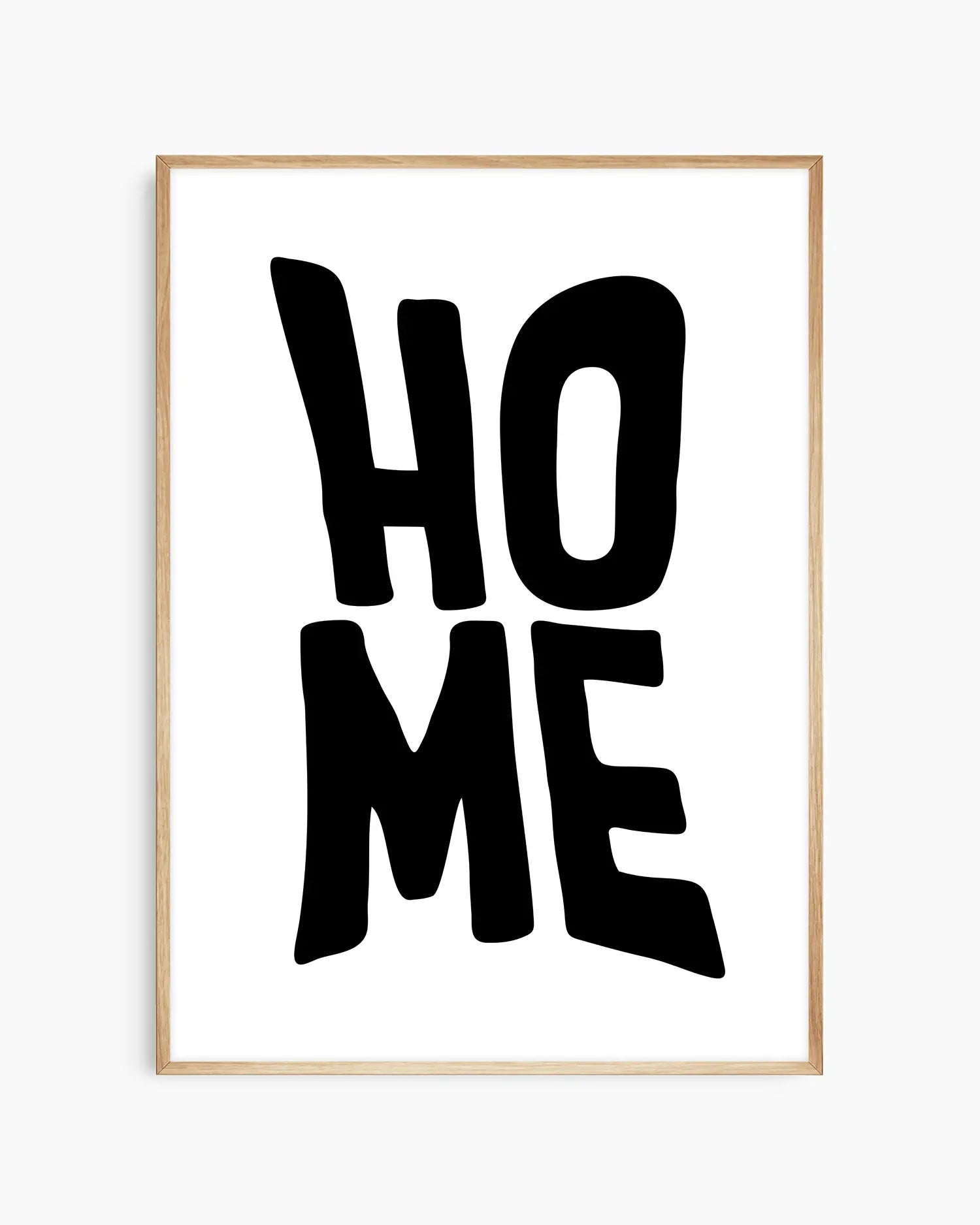 Framed artwork with 'HOME' text on a white background in an oak wooden frame.