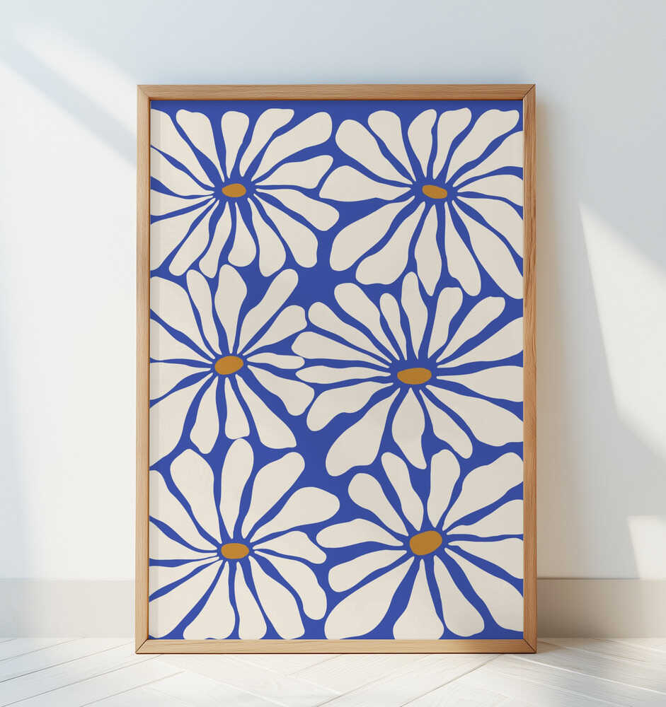Framed poster of big white flowers on a blue background on a white wall